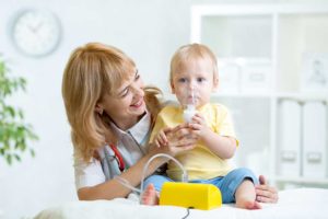 respiratory therapist working with child